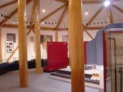 大きな柱が何本かある多角形の室内に、資料や衣装が展示されている写真